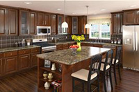 A kitchen with brown cabinets and a center island.