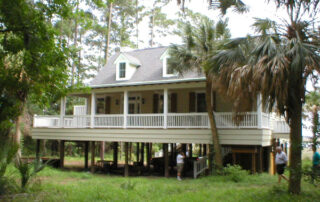 A house in the woods with a porch.
