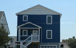 A house with a blue roof and white siding.