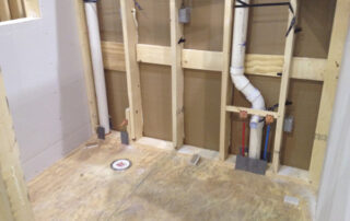 A bathroom is being remodeled with pipes and pipes.