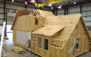 A house being built in a warehouse.