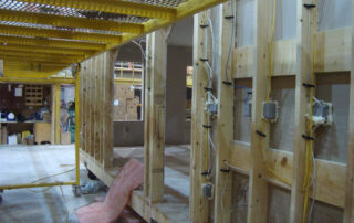 A room being built with wood framing and wires.