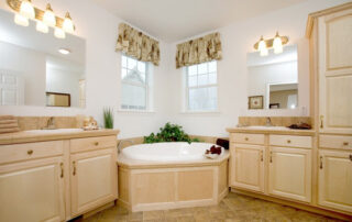 A bathroom with a jacuzzi tub and two sinks.