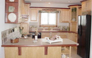 A kitchen with beige cabinets and counter tops.