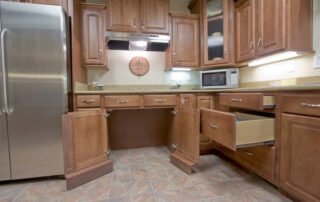 A kitchen with wooden cabinets and a refrigerator.