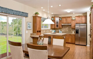 A kitchen with wooden cabinets and a dining table.