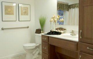 A bathroom with brown cabinets and a toilet.