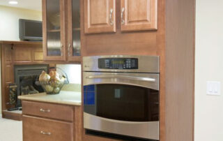 A kitchen with brown cabinets and an oven.