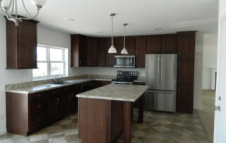 A kitchen with brown cabinets and stainless steel appliances.