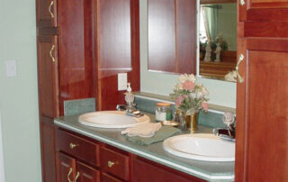 A bathroom with two sinks and a mirror.
