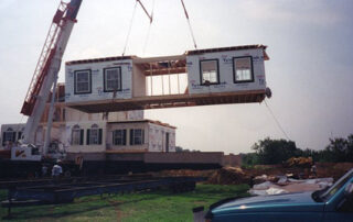 A house being lifted by a crane.