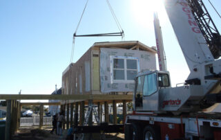 A crane lifting a house.