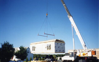 A crane lifting a house.