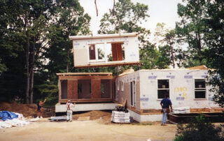 A house being built with a crane.