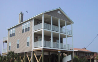 A beach house with a balcony.