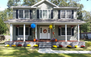A home with a front porch decorated for fall.