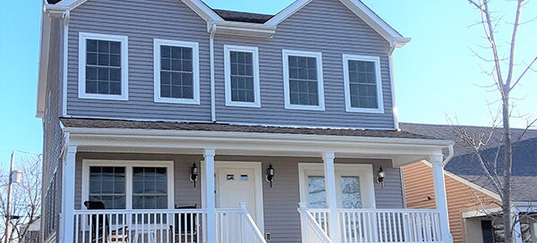 A house with two stories and a porch.